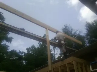 Carpenter setting a ridge beam over a new addition frame — Ice Dam Removal by Roofing Brothers in Belvedere Tiburon