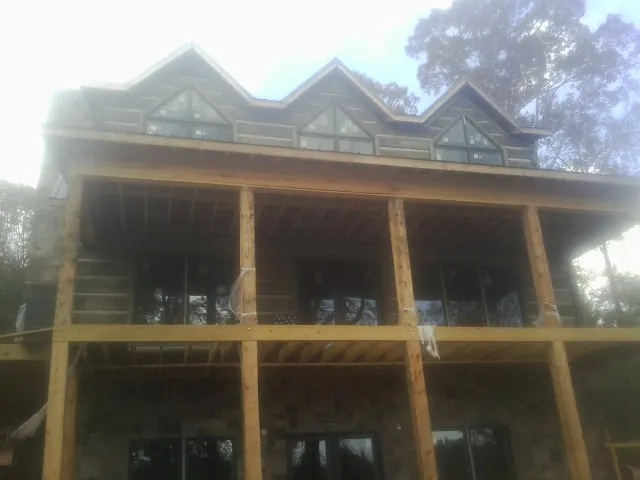 Dormers and porch framing on a large log home under construction — Roof Coating work by our crew in Belvedere Tiburon
